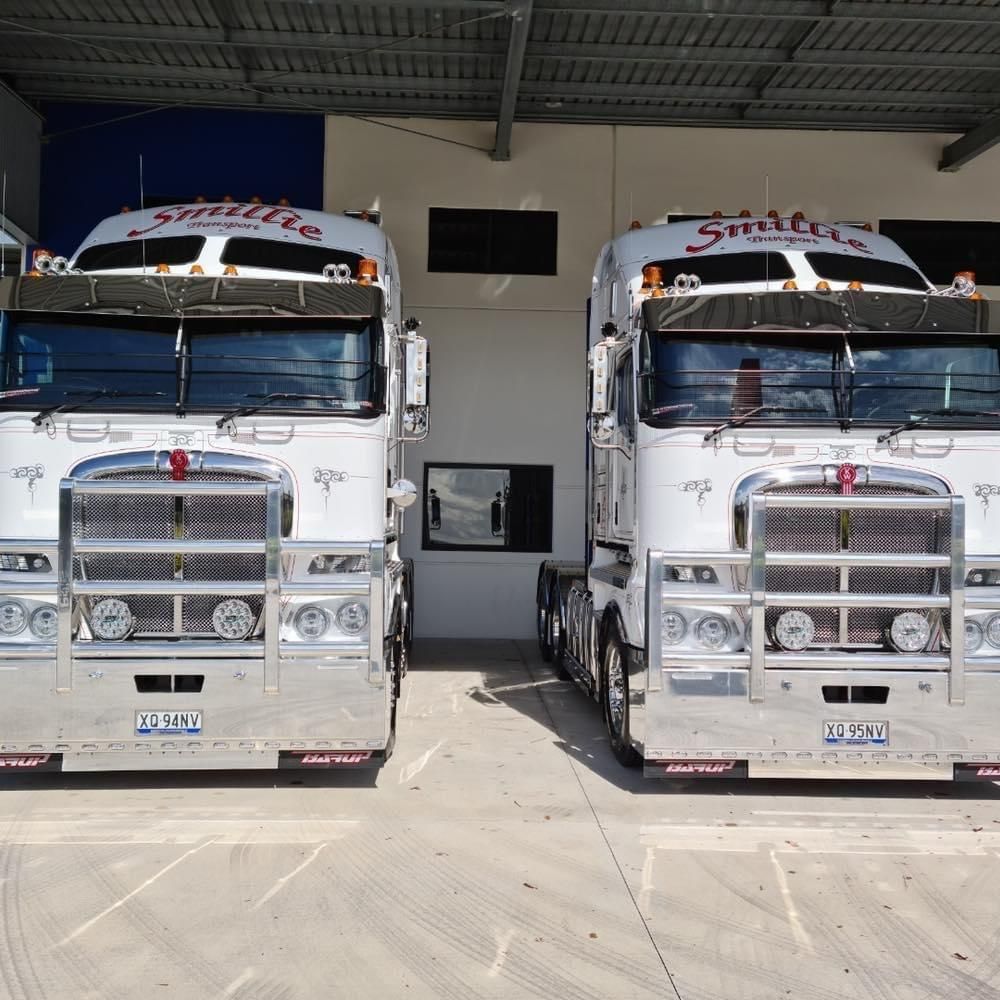 Two Semi Trucks Are Parked Next to Each Other — Smillie Transport Pty Ltd in Two Mile, QLD