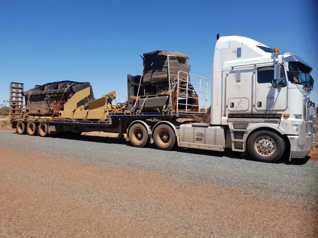 A White Semi Truck Is Carrying a Large Piece of Equipment — Smillie Transport Pty Ltd in Two Mile, QLD