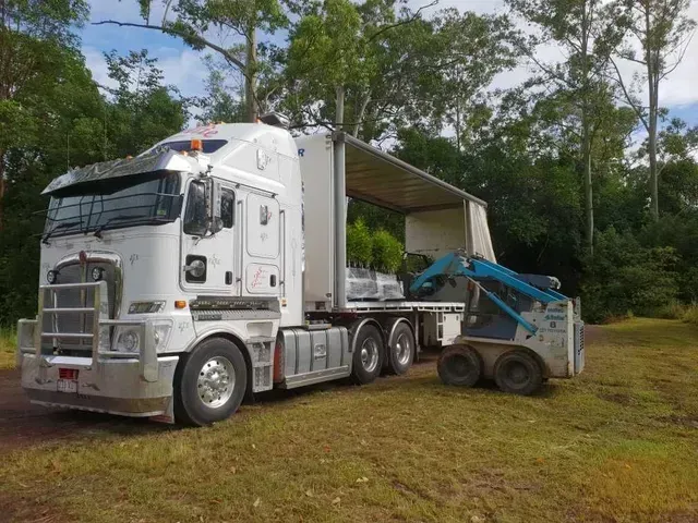 A Large White Semi Truck Is Parked in A Dirt Lot — Smillie Transport Pty Ltd in Two Mile, QLD