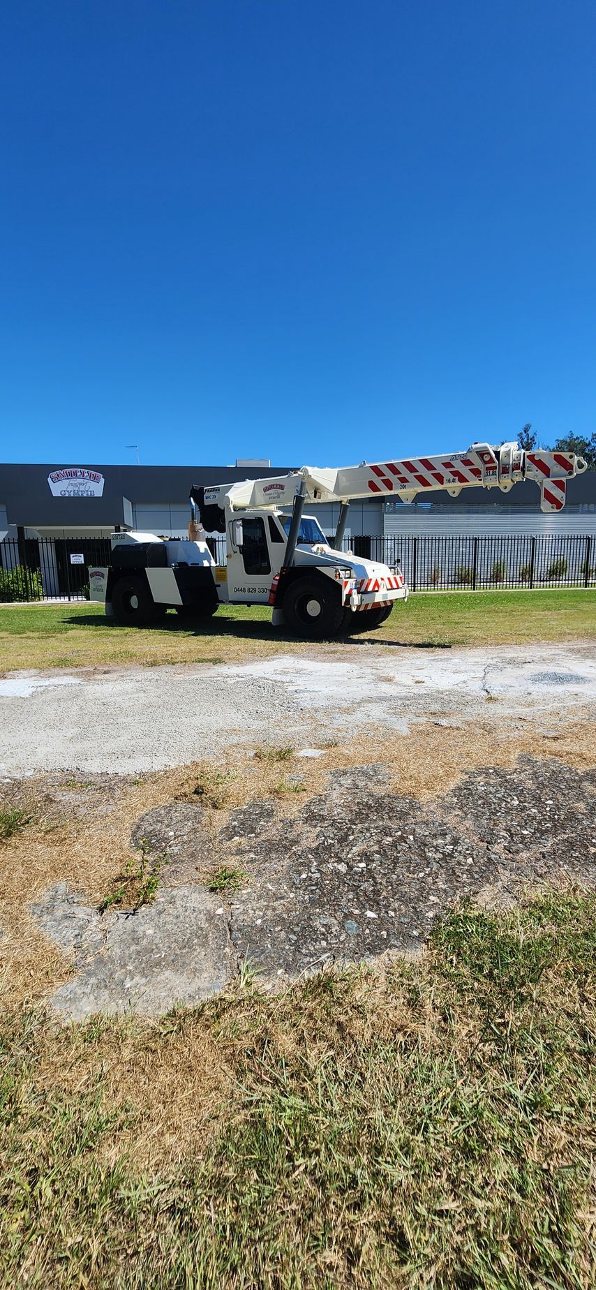 Utility Truck Parked on a Sunny Roadside Beside a Fence — Smillie Transport Pty Ltd in Two Mile, QLD