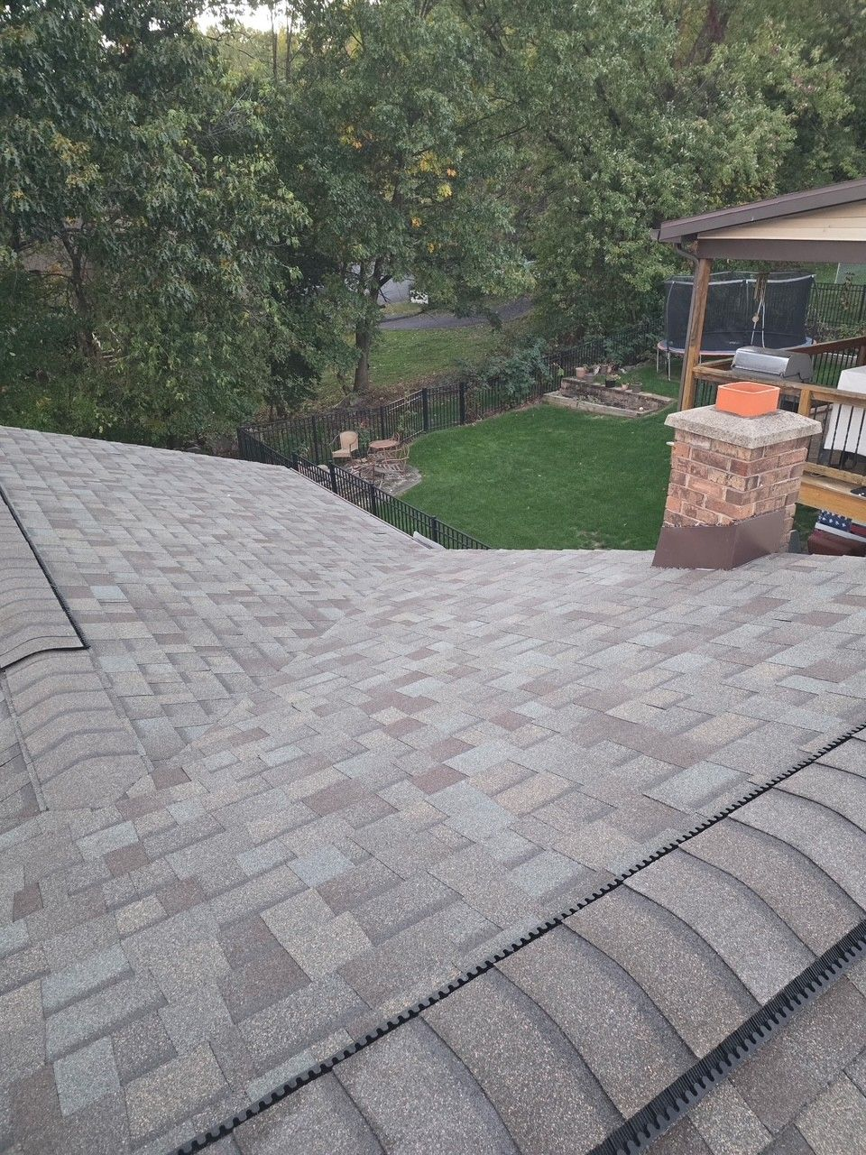 Licensed NJB Construction roofer repairing storm-damaged shingles on a residential roof in Luzerne County, PA