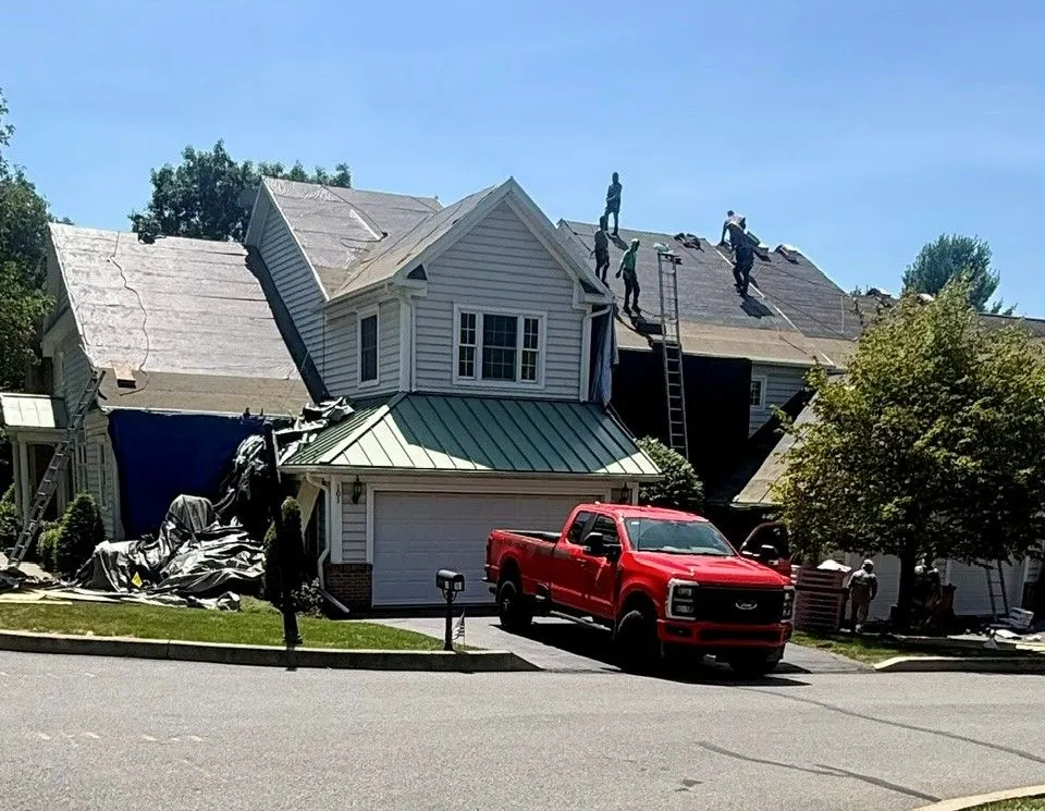 NJB Construction and Roofing roofer repairing storm-damaged shingles on a Susquehanna County residential roof