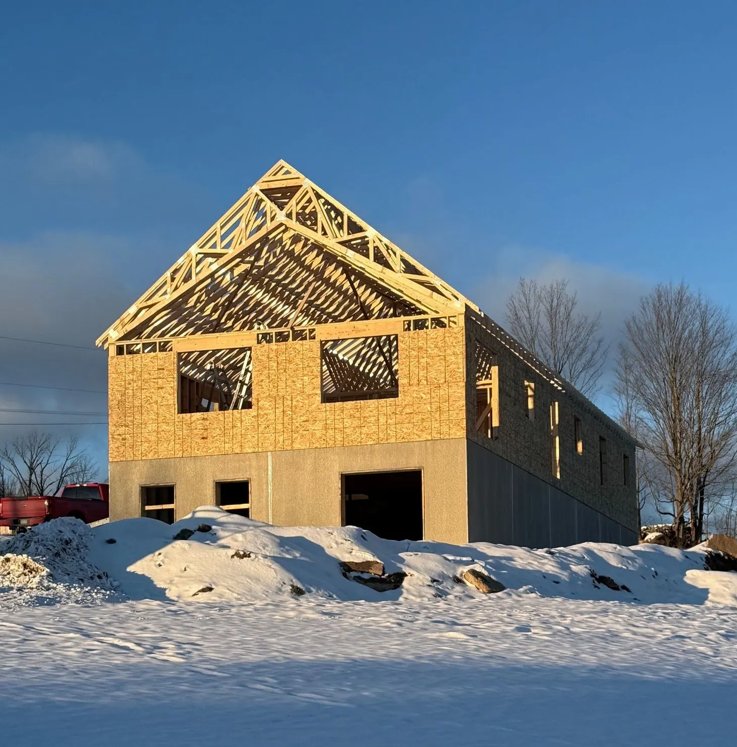 Snow-loaded residential roof in Monroe County, PA showing ice dam damage on asphalt shingles.