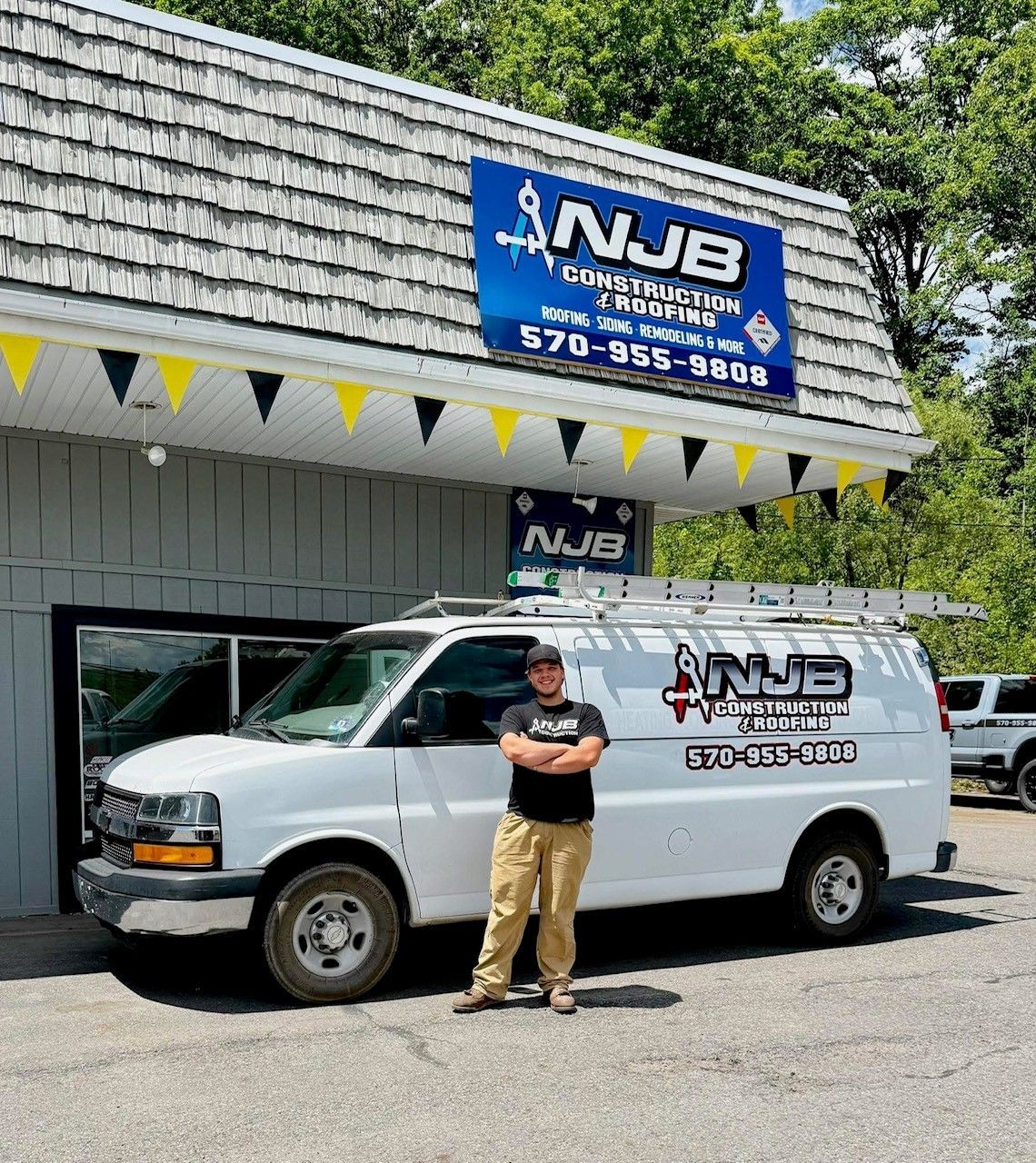 Father and son roofing team working together on a residential roof in Northeast Pennsylvania