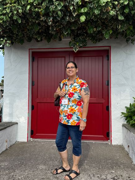 Theresa Heine smiling outdoors on a cobblestone street