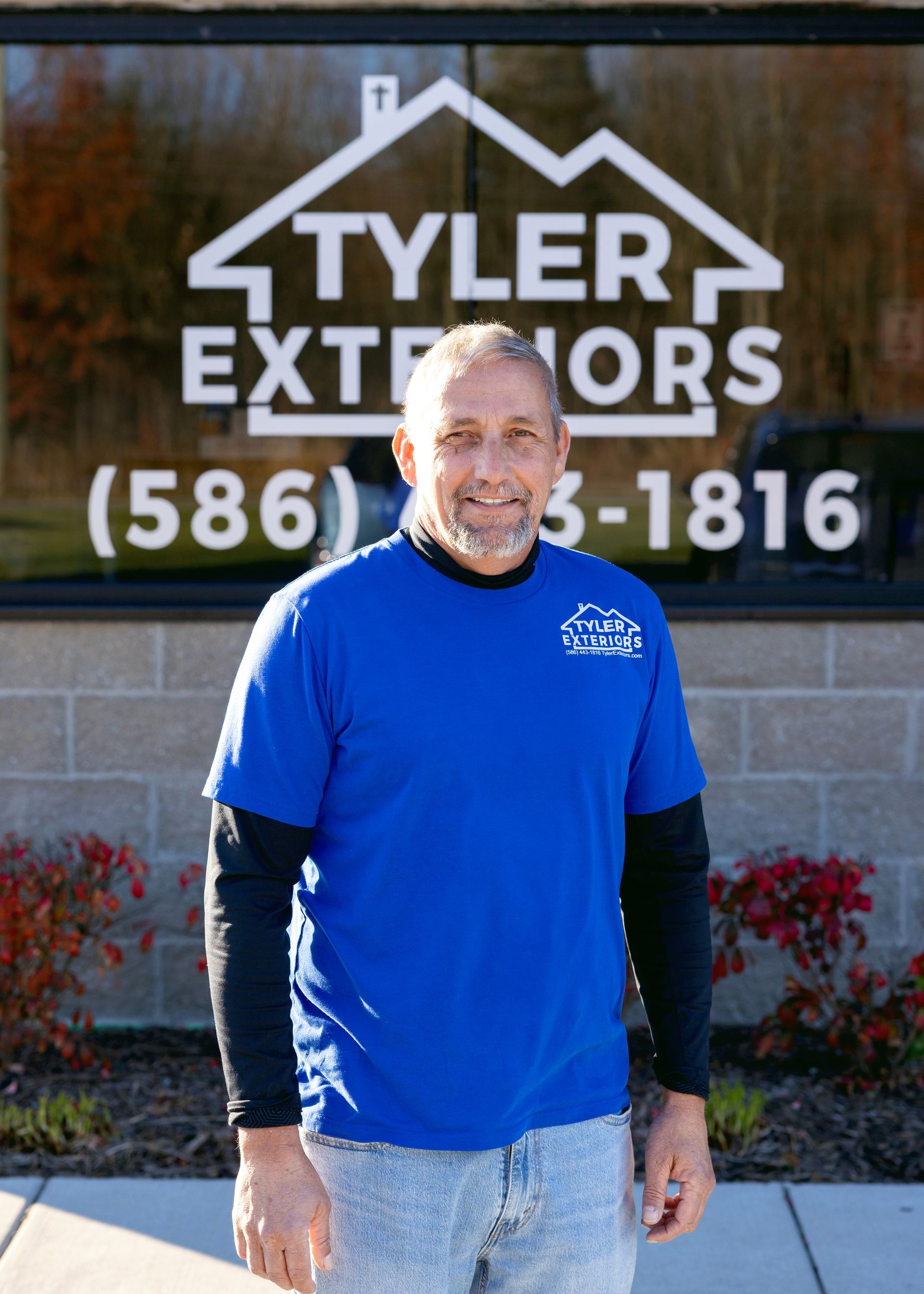 Man in blue shirt in front of 