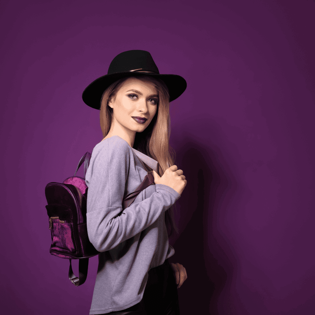 AI & Machine Learning Recruitment specialist in a dark sweater standing against a light purple background, looking to the side.