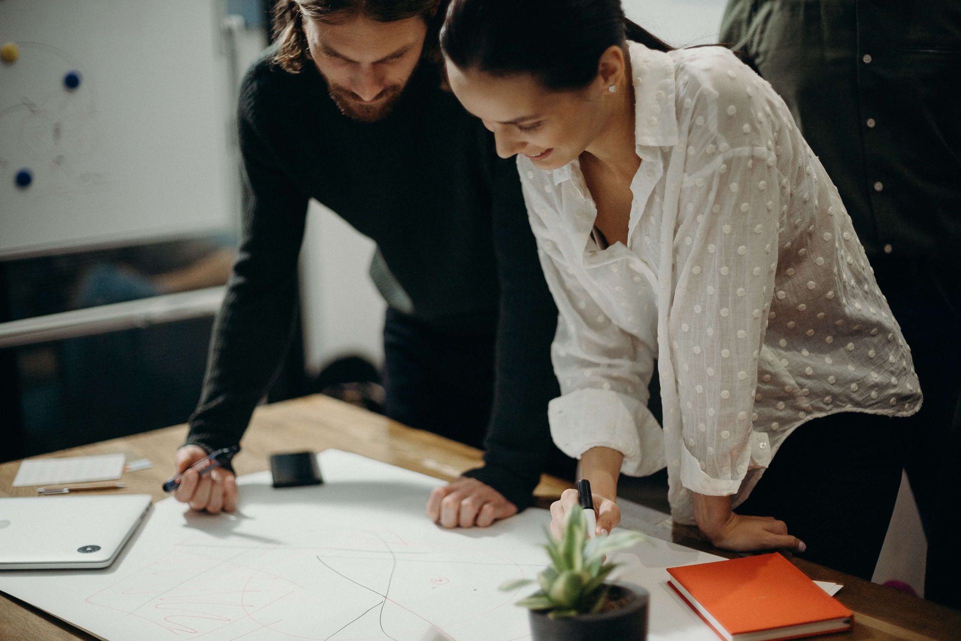 Two people looking at workforce planning document