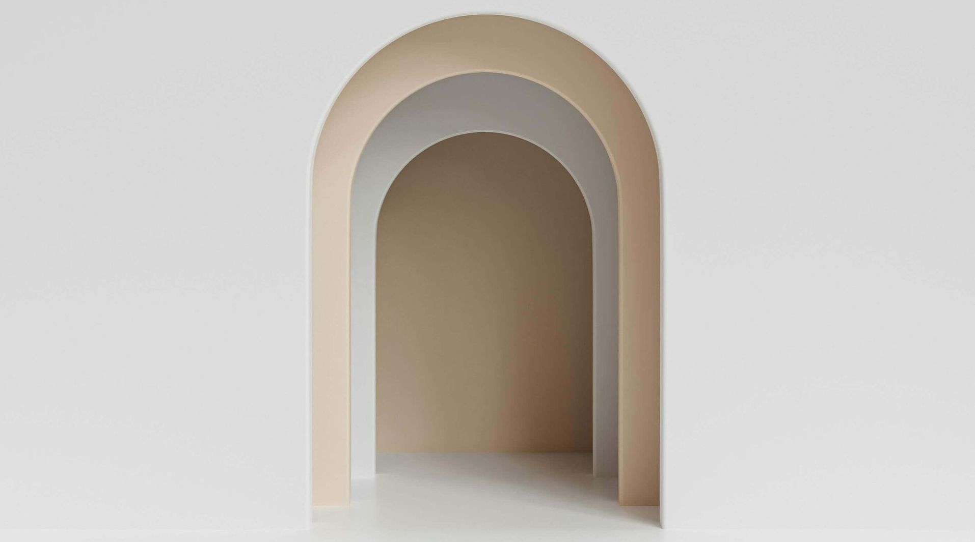 White and beige arched doorway within a white wall, creating a layered, minimalist design.