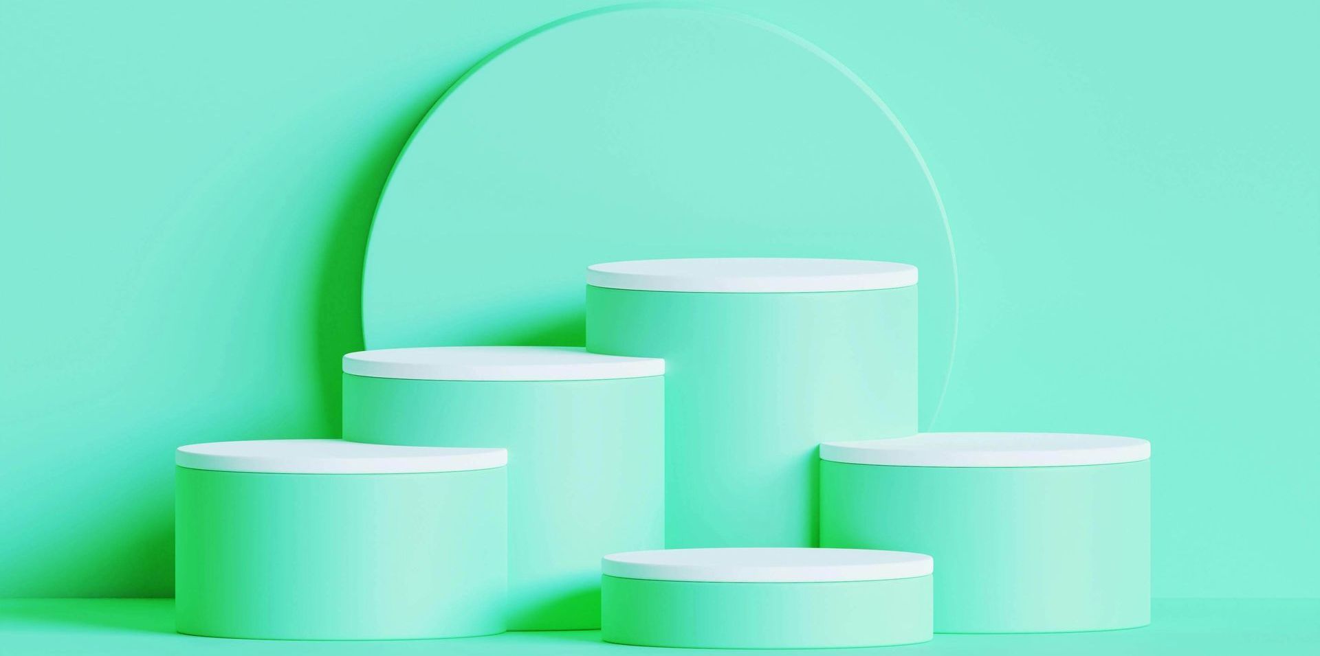 Mint-coloured display podiums with white tops and a rounded backdrop.
