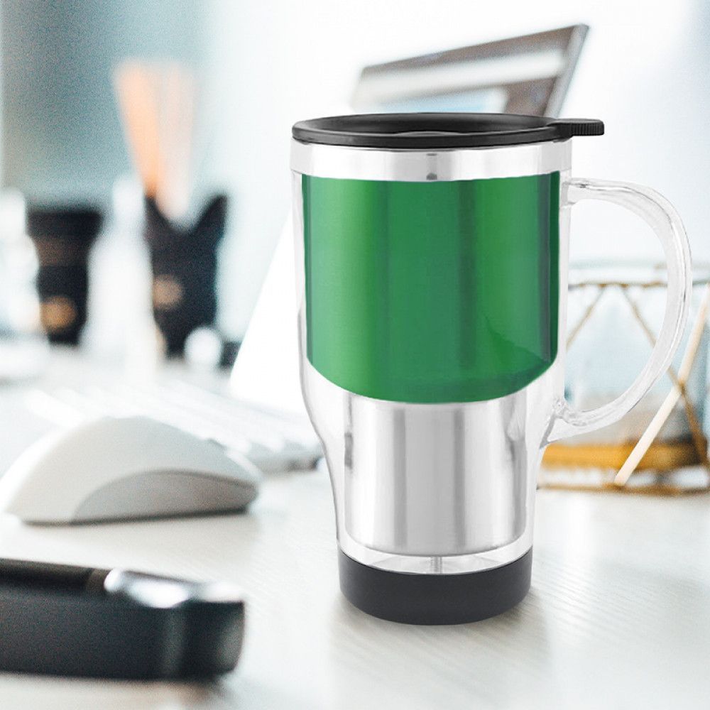 Green insulated travel mug with clear handle and black lid on a desk, with blurred office items in background
