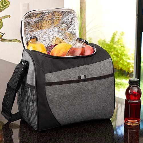 Insulated lunch bag with fruit and a foil container on a kitchen counter