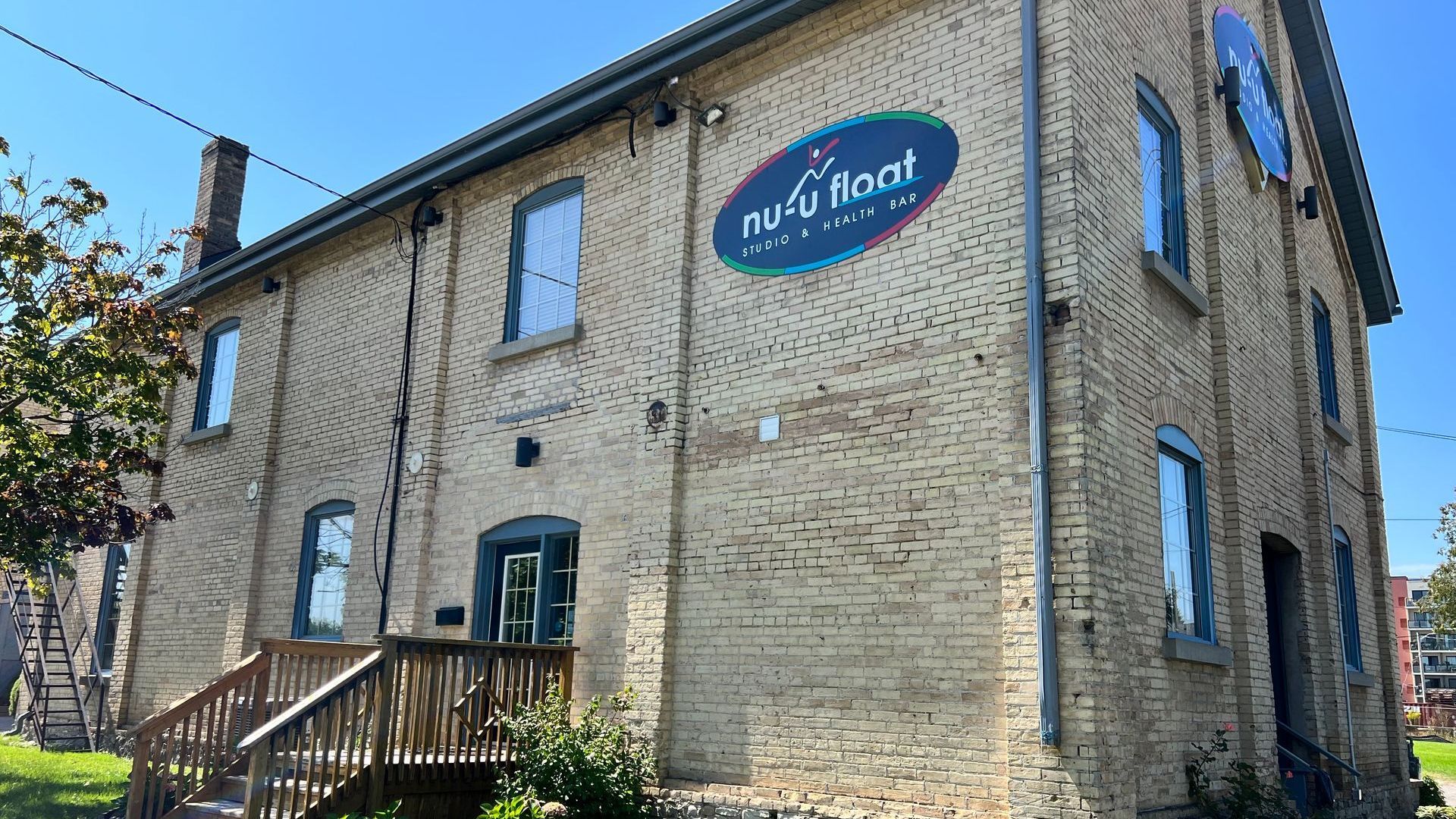 A large brick building with a sign on the side that says purple real.