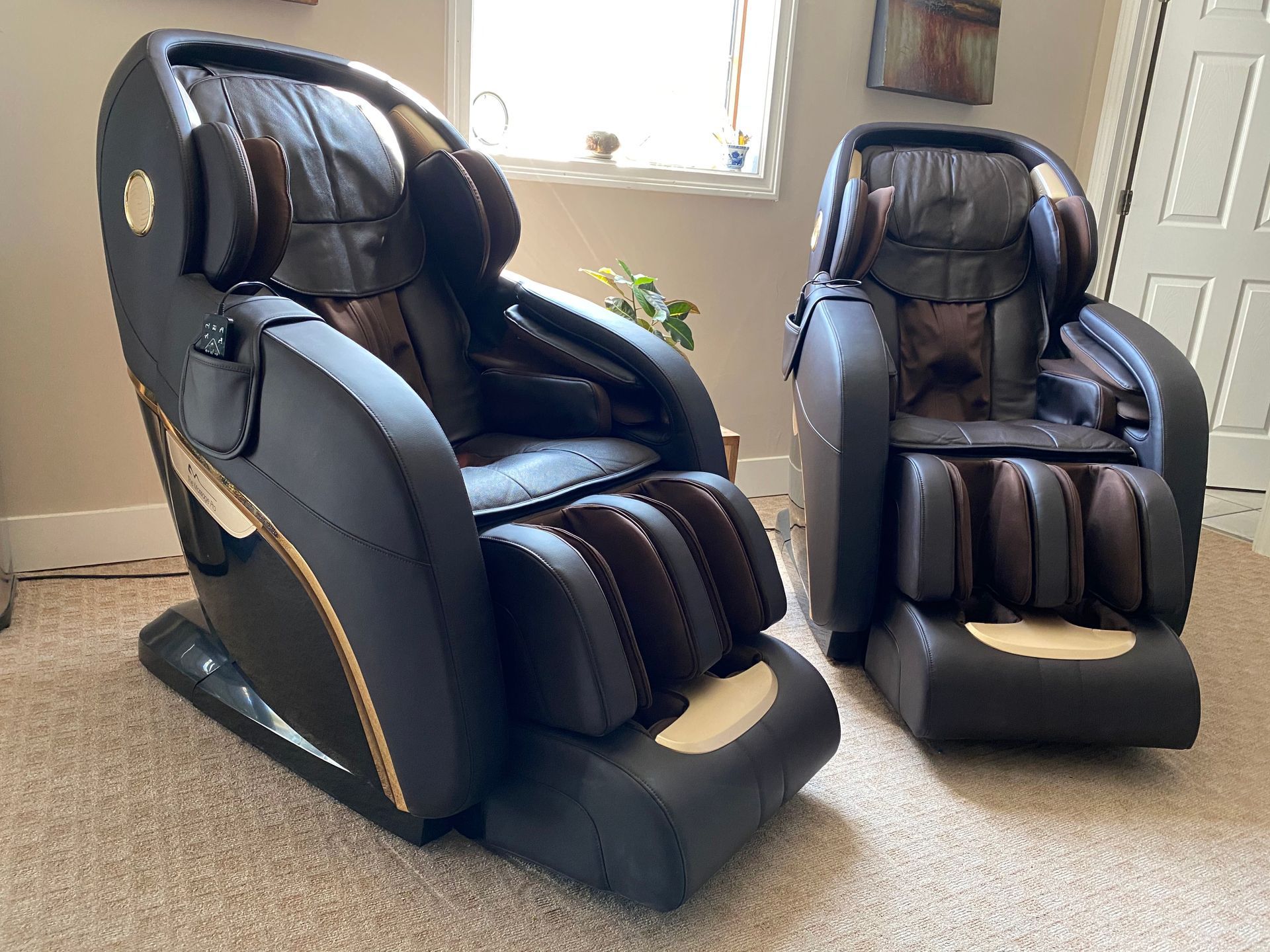 Two massage chairs are sitting next to each other in a living room.