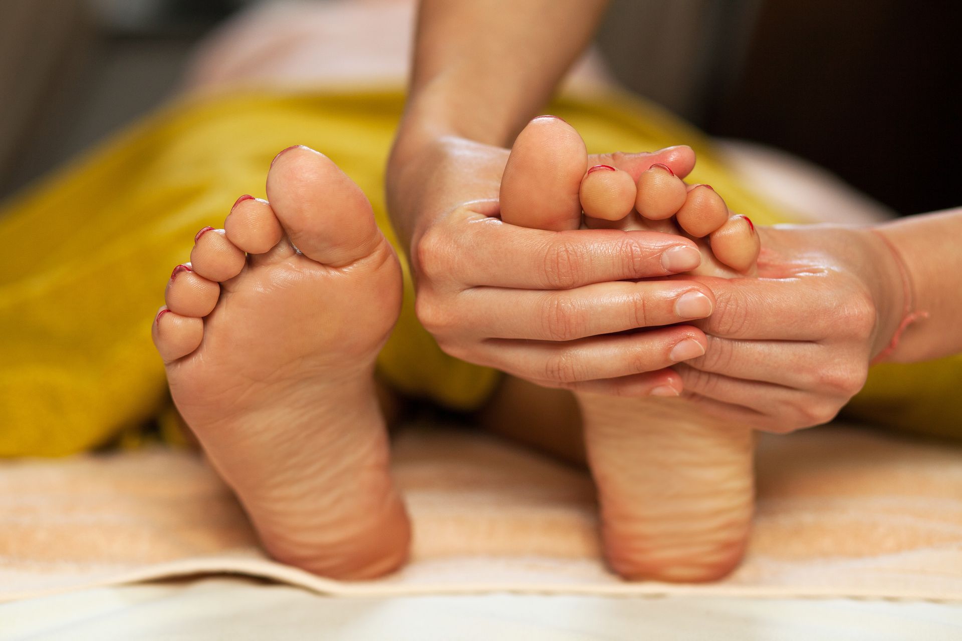 A woman is getting a foot massage in a spa.