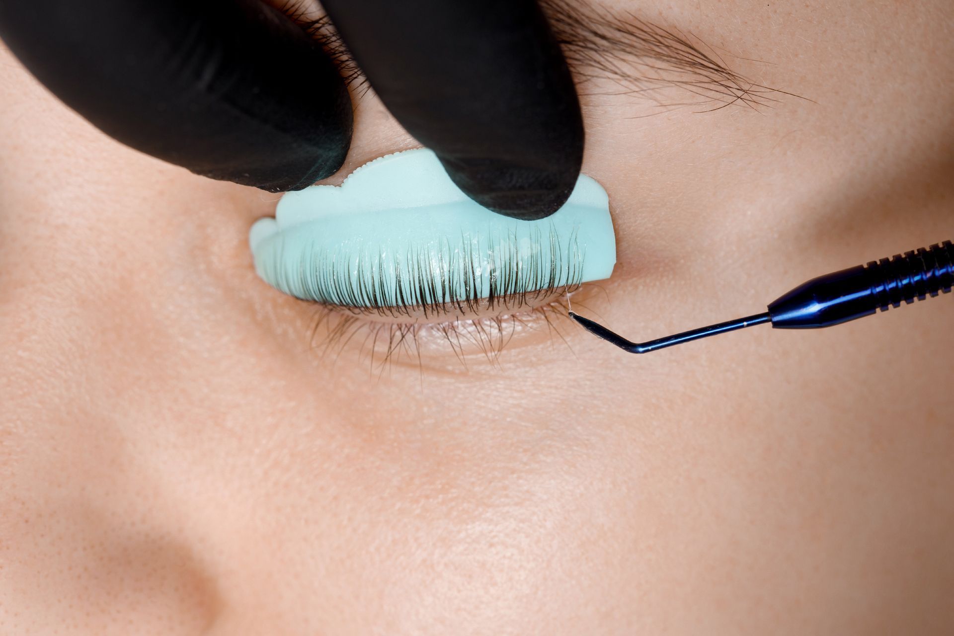 A close up of a woman 's eye with a brush on it.