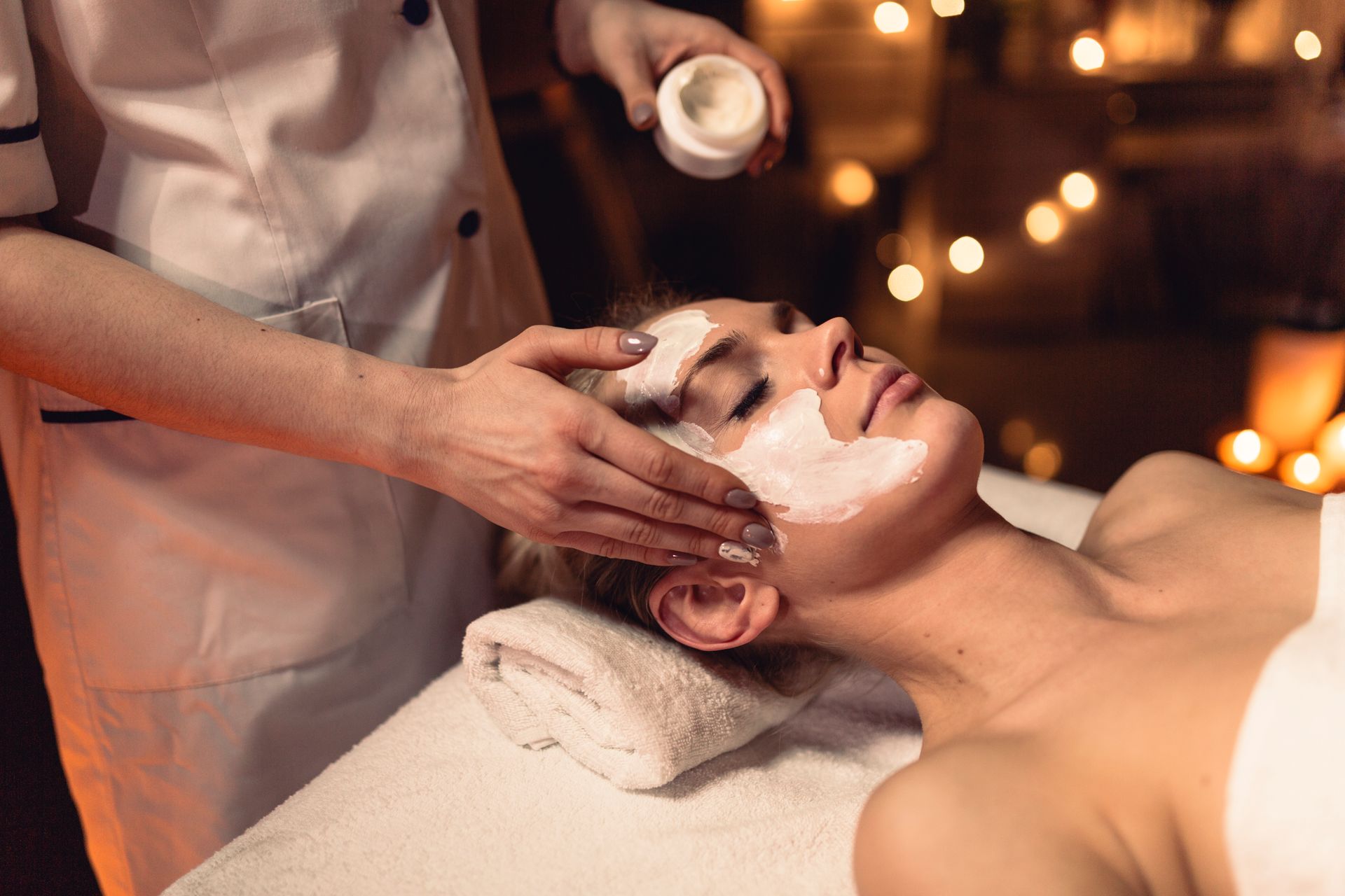 A woman is getting a facial treatment at a spa.