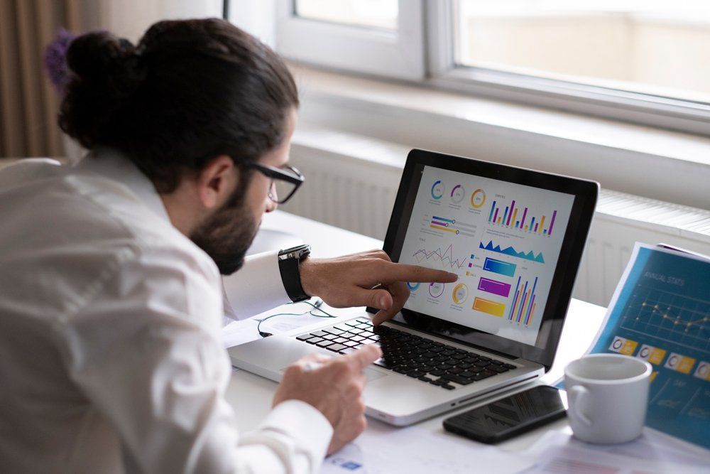 Man Looking At Graph On Laptop — Okmulgee, OK — Greg Marriott CPA PLLC Man Looking At Graph On Laptop — Okmulgee, OK — Greg Marriott CPA PLLC