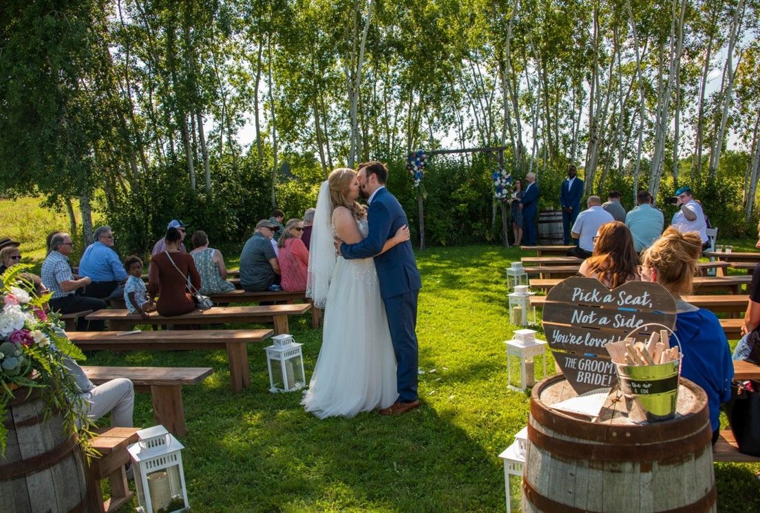 couple kiss at a wedding reception at Poplar Creek Barn in Oshkosh Wisconsin, Sound Sensations Entertainment