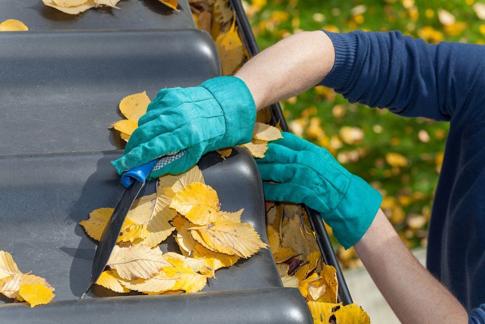 Man Cleaning Roof Before Painting