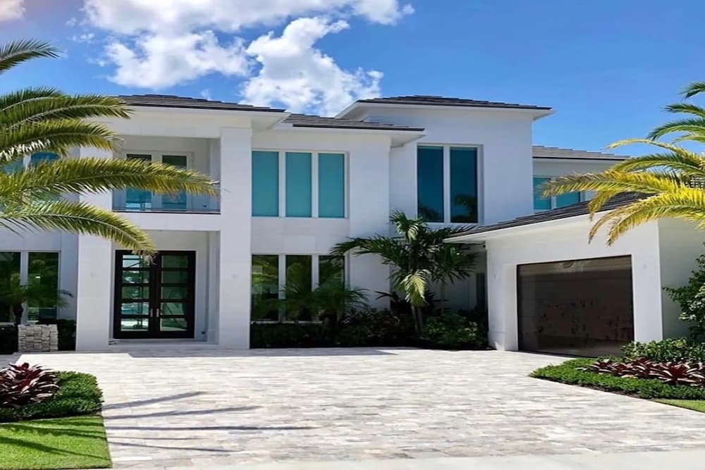 White luxury, beach house with impact entryway door.