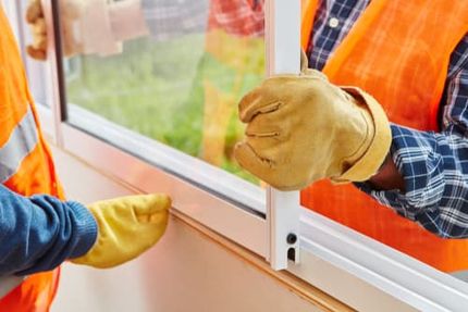 Workers install a window.