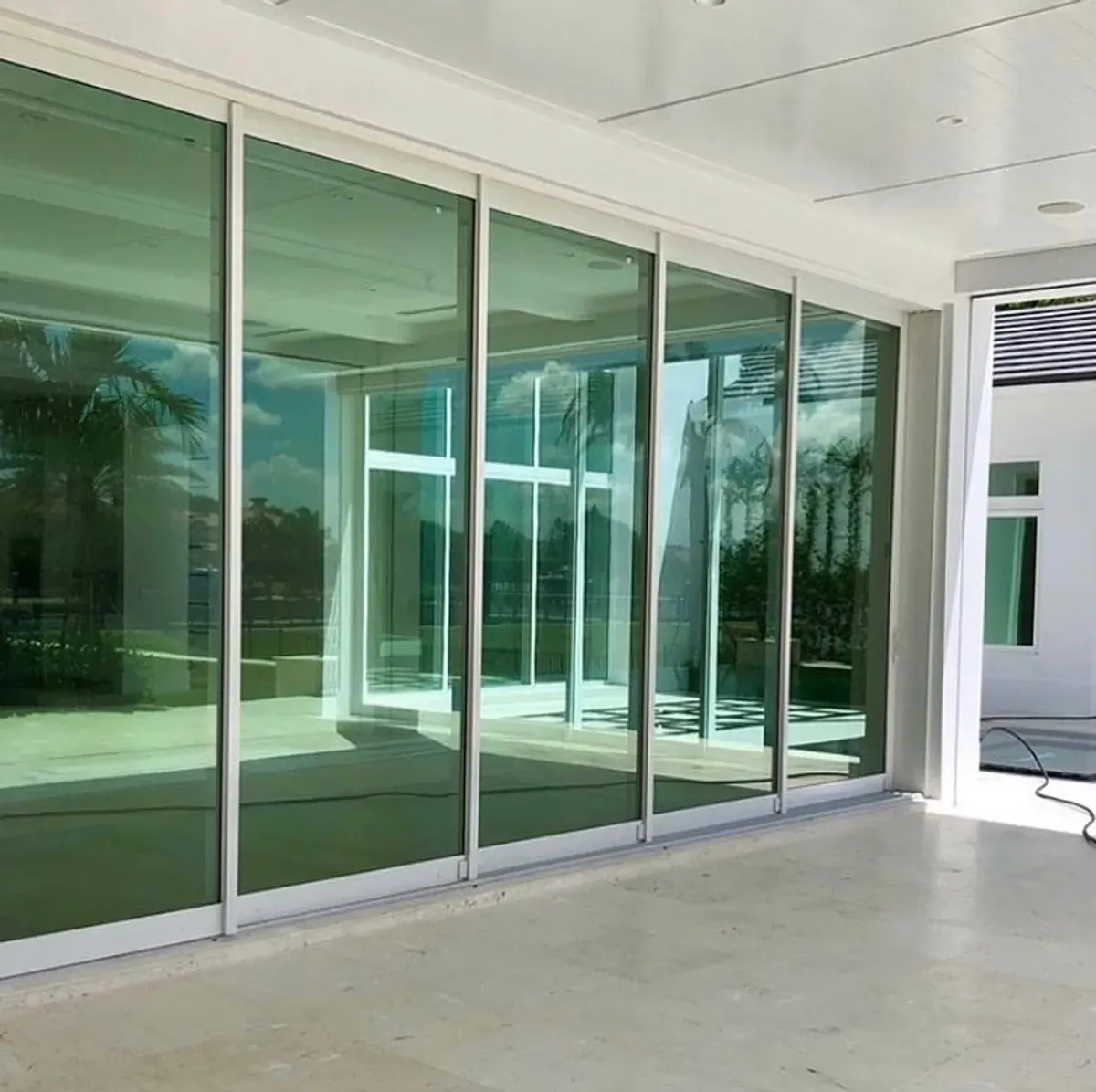 White luxury, beach house with impact entryway door.