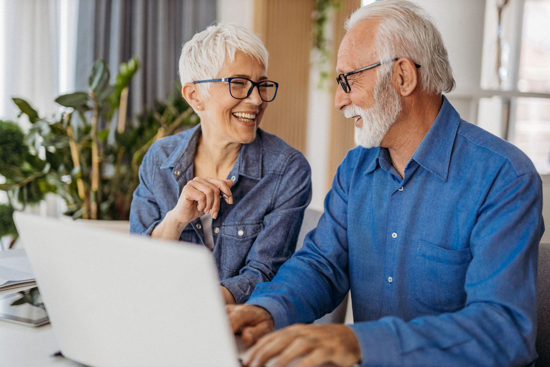 Woman sitting at a table looking at her laptop