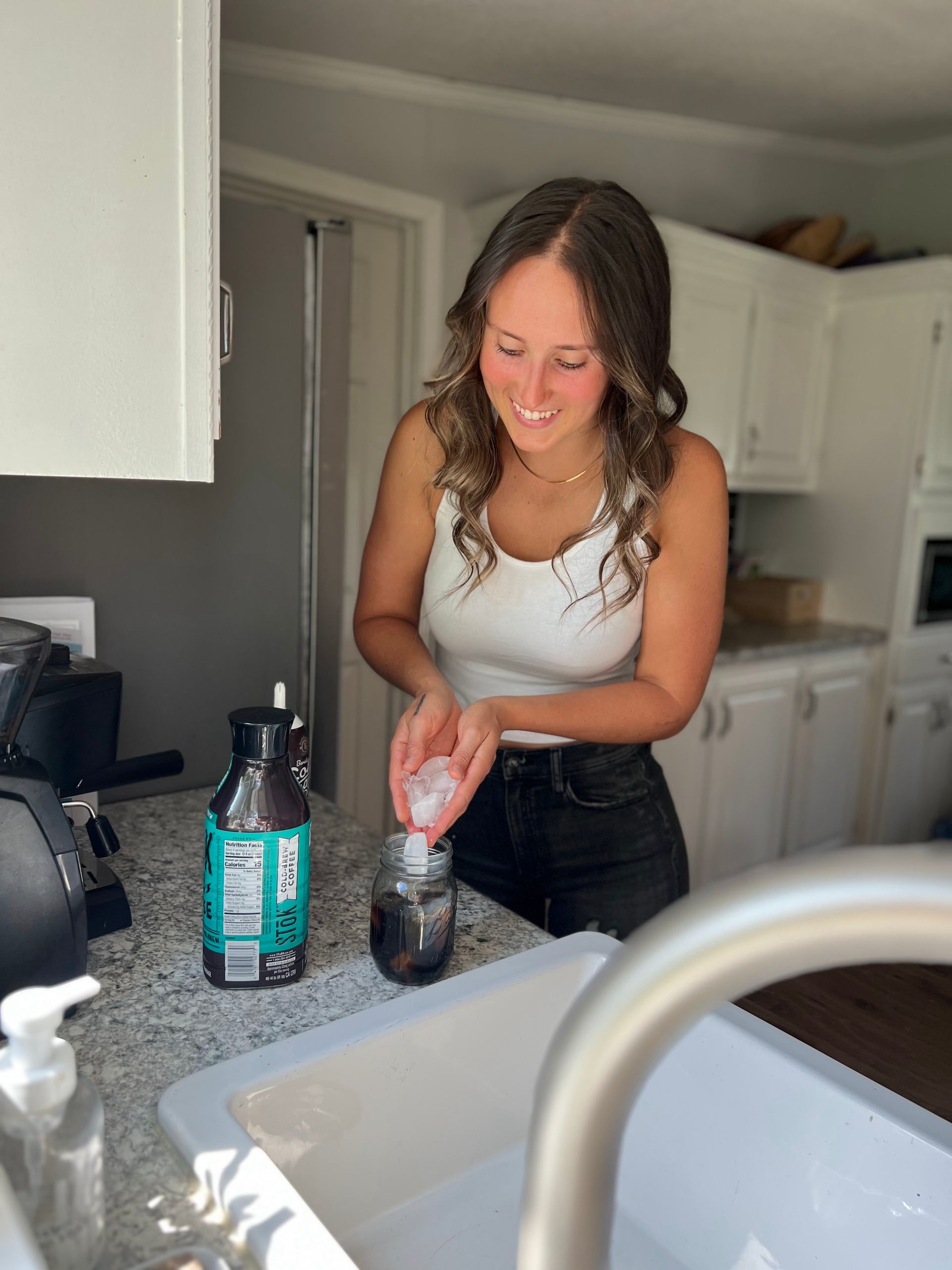 Jourdan prepares a healthy, wholesome snack in her client's bright kitchen.
