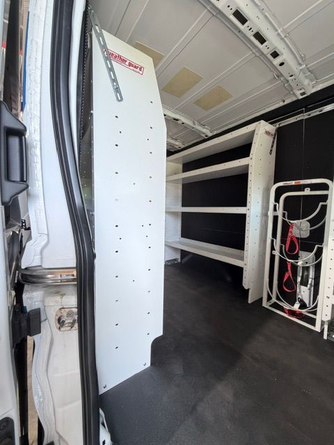 Interior of a white utility van with shelving units and cargo storage inside
