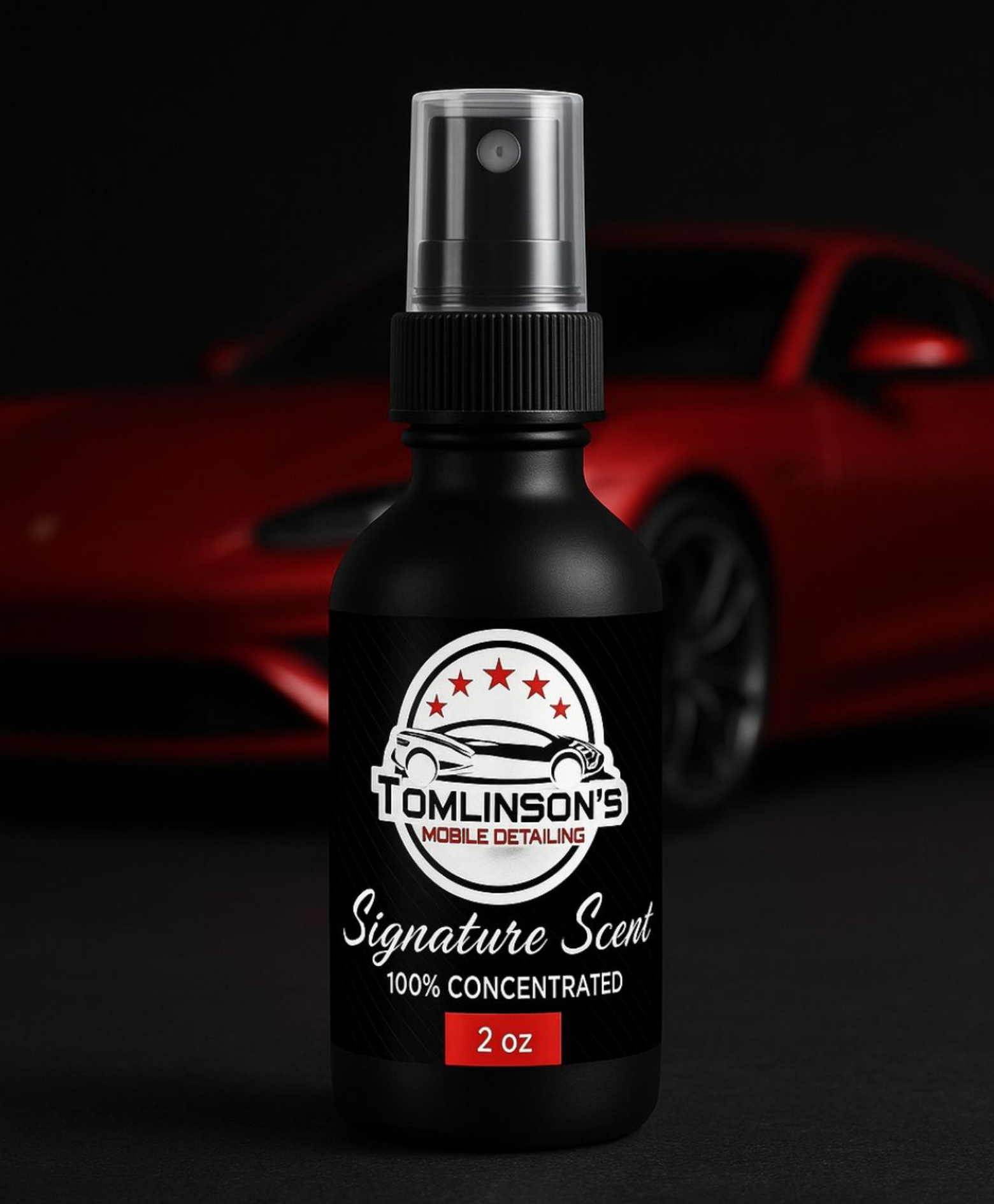 Black Tomlinson’s Signature Suds spray bottle with a red sports car in the background.