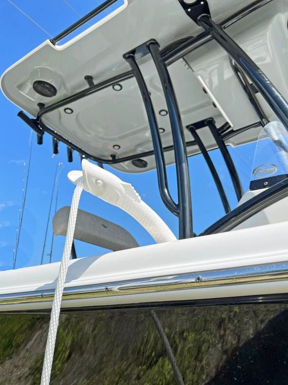 a white boat with a rope attached to it