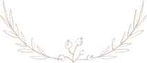 Delicate beige floral wreath with leaves and small blossoms framing a blank center