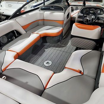 The inside of a boat with gray and orange seats