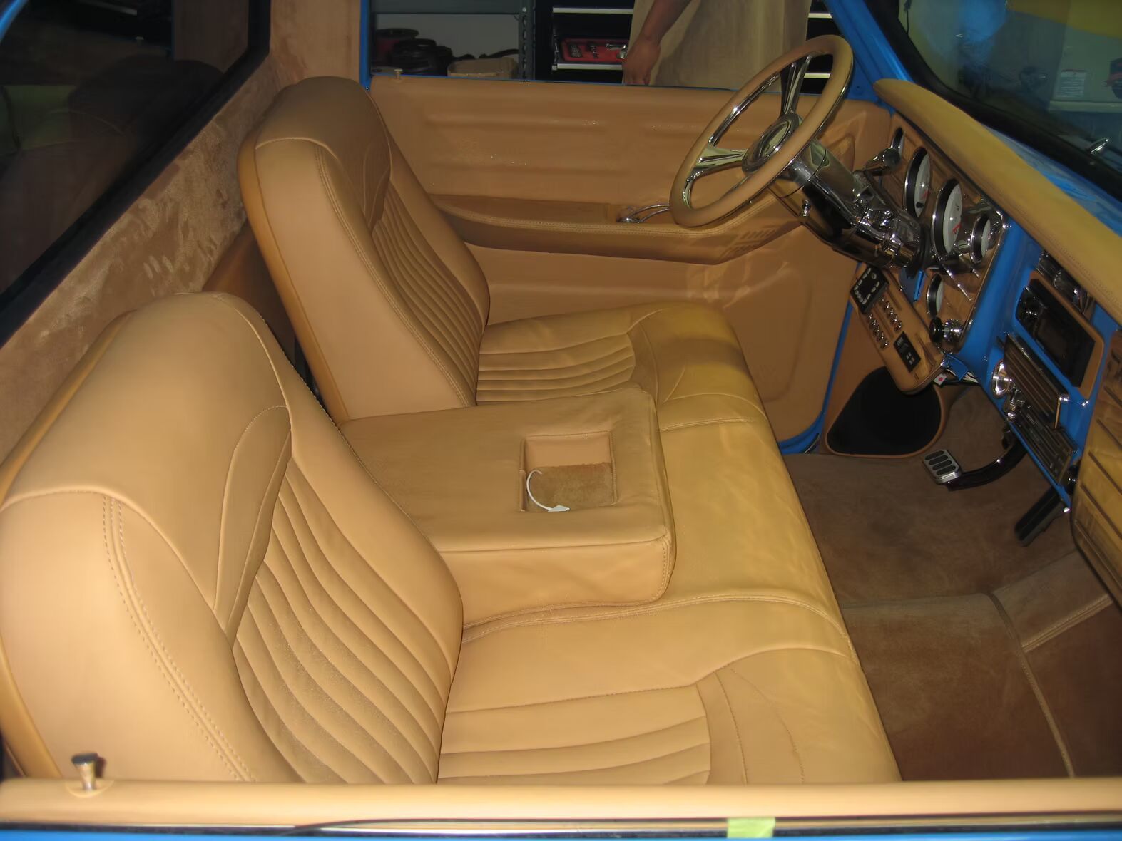A blue truck with tan leather seats and a steering wheel