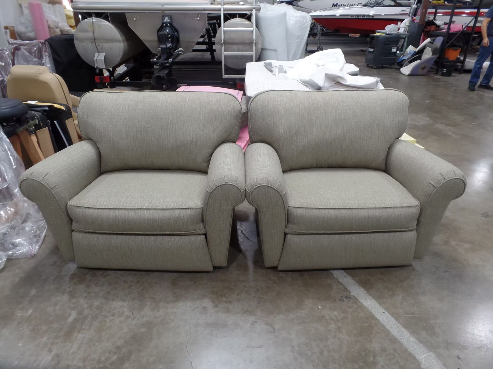 Two chairs are sitting next to each other in a warehouse