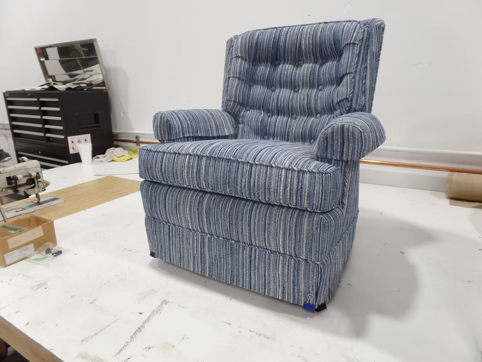 A blue chair is sitting on top of a white table.