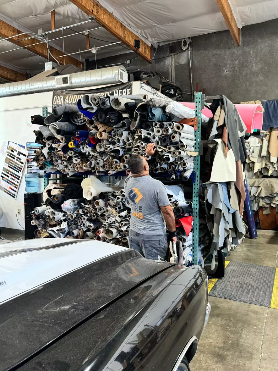 A man is standing in front of a pile of junk in a garage.