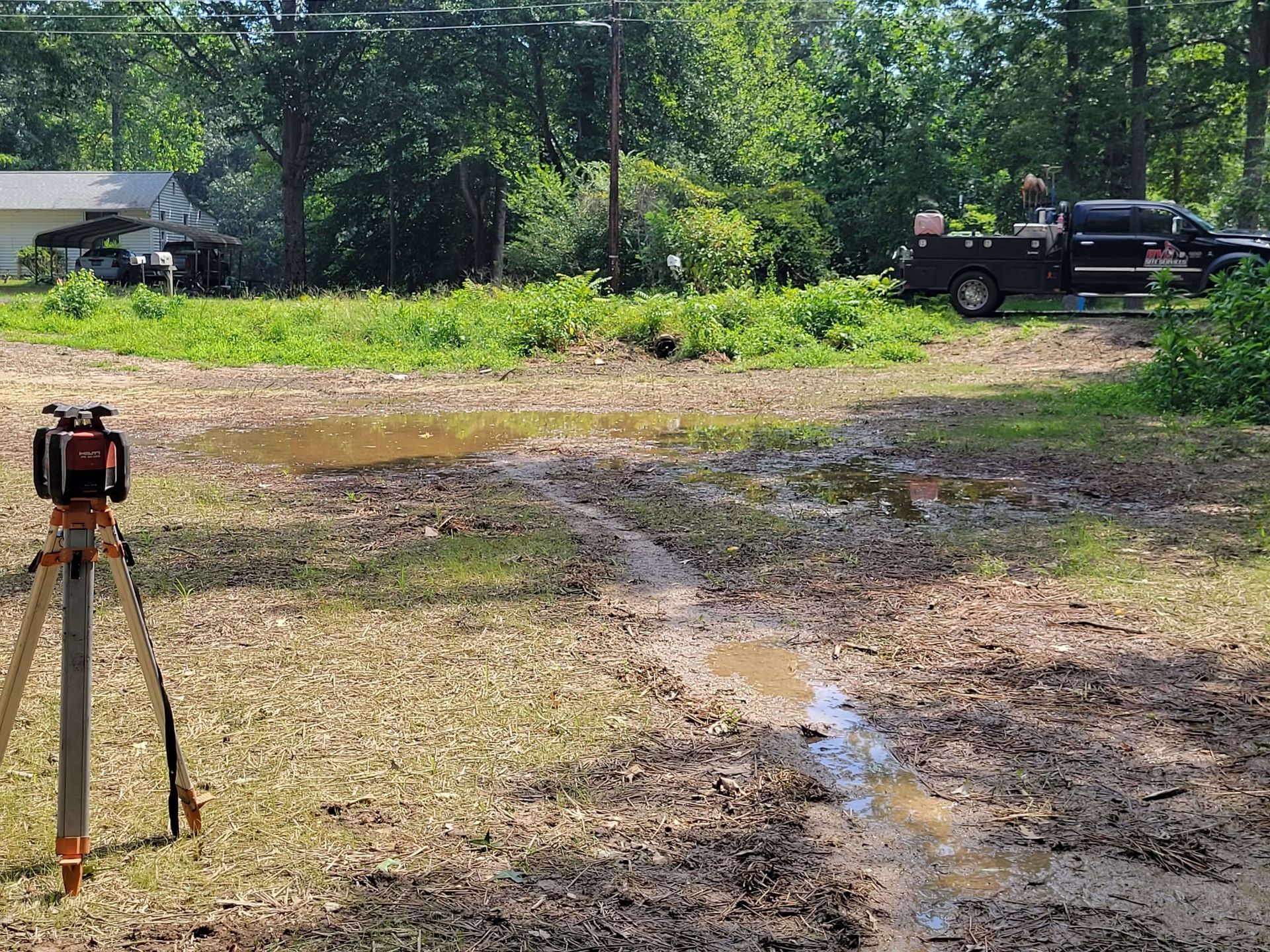 Grading uneven terrain to improve water flow and reduce standing water
