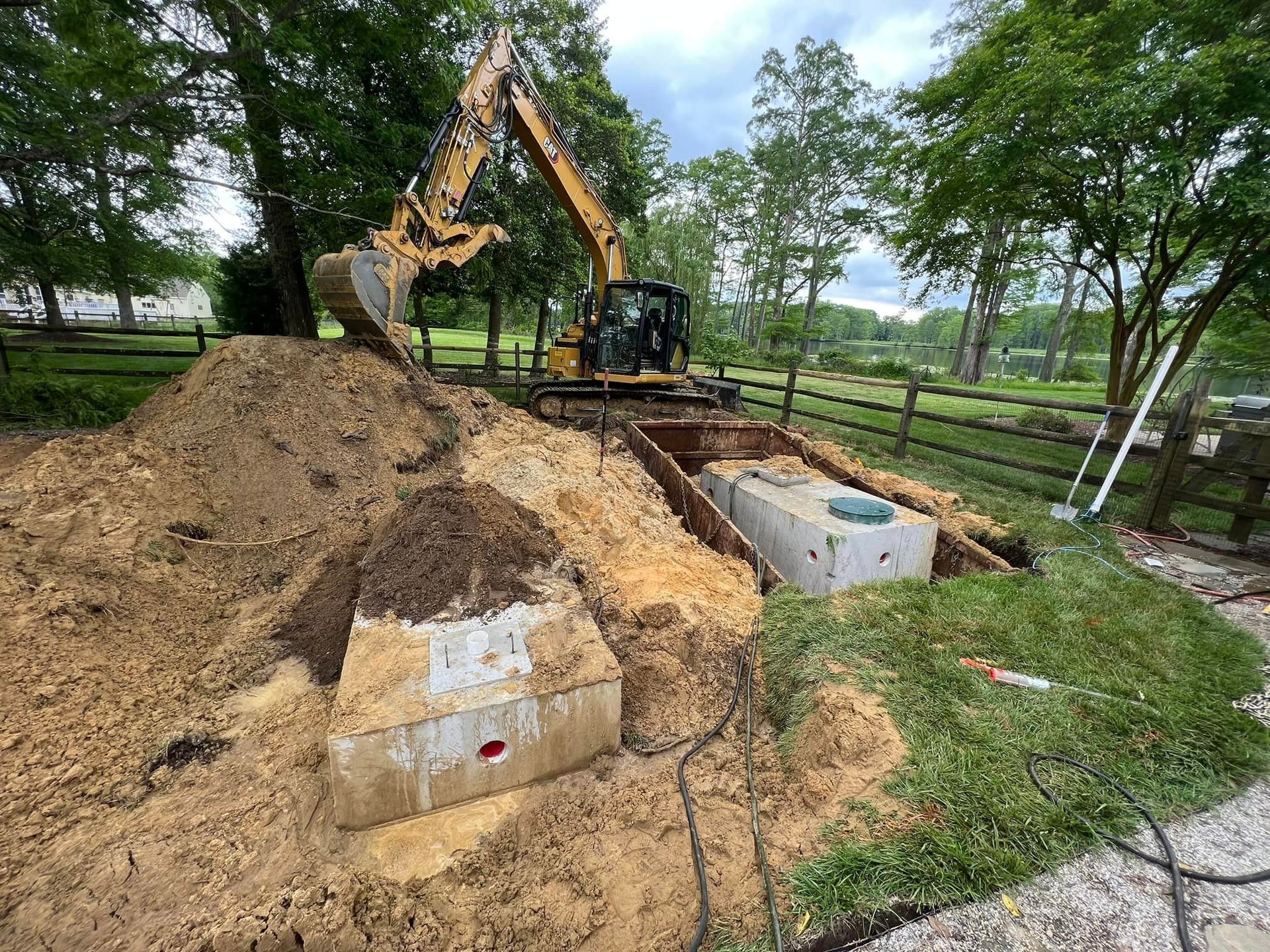 Excavator moving soil and earth during residential site work in Central Virginia