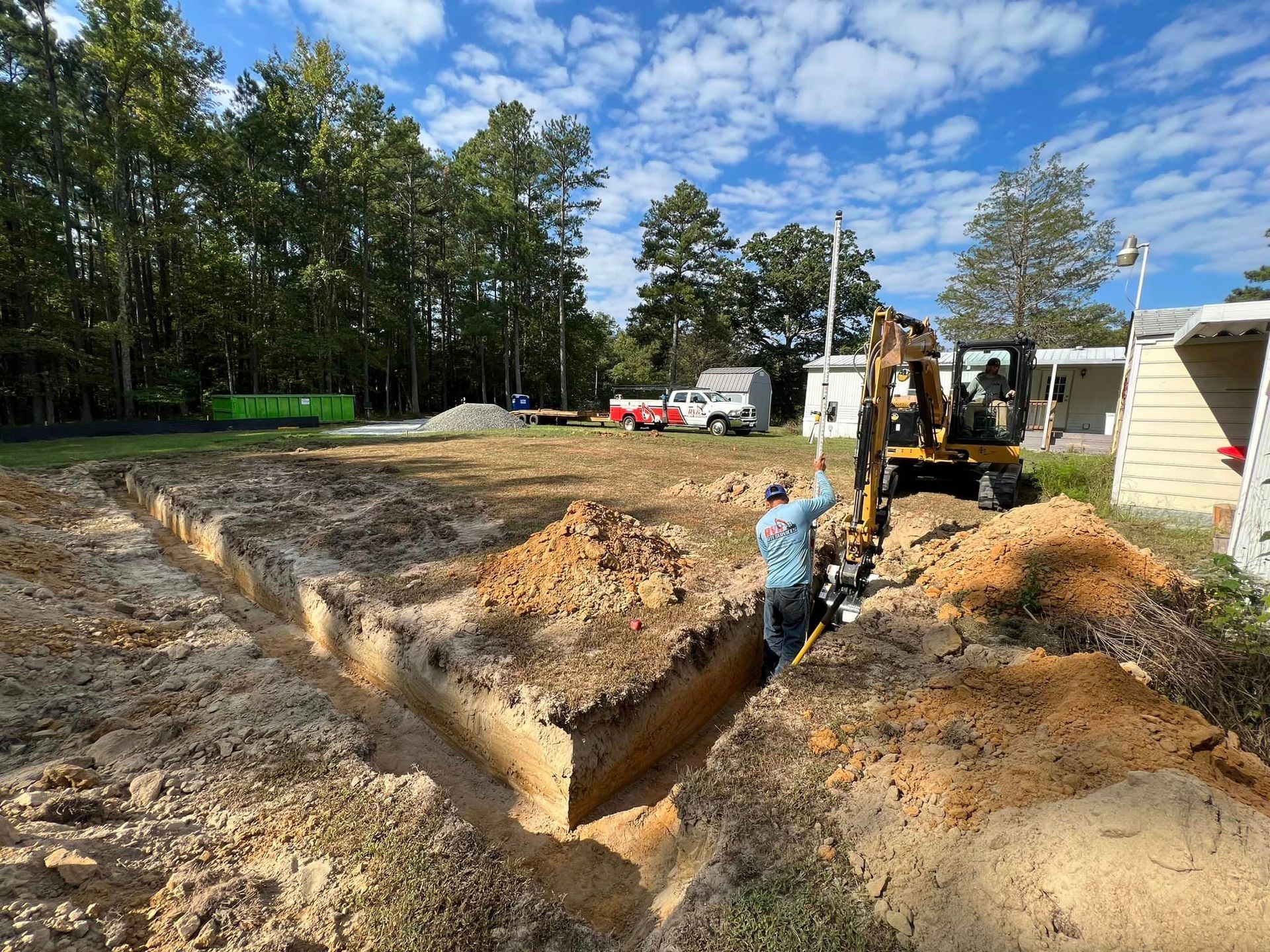 Excavator preparing ground for a septic system and underground site work