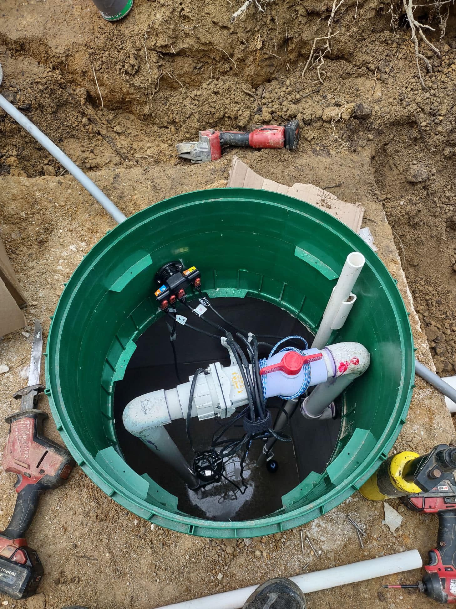 RVA Site Services repairing a septic pump inside a septic tank.