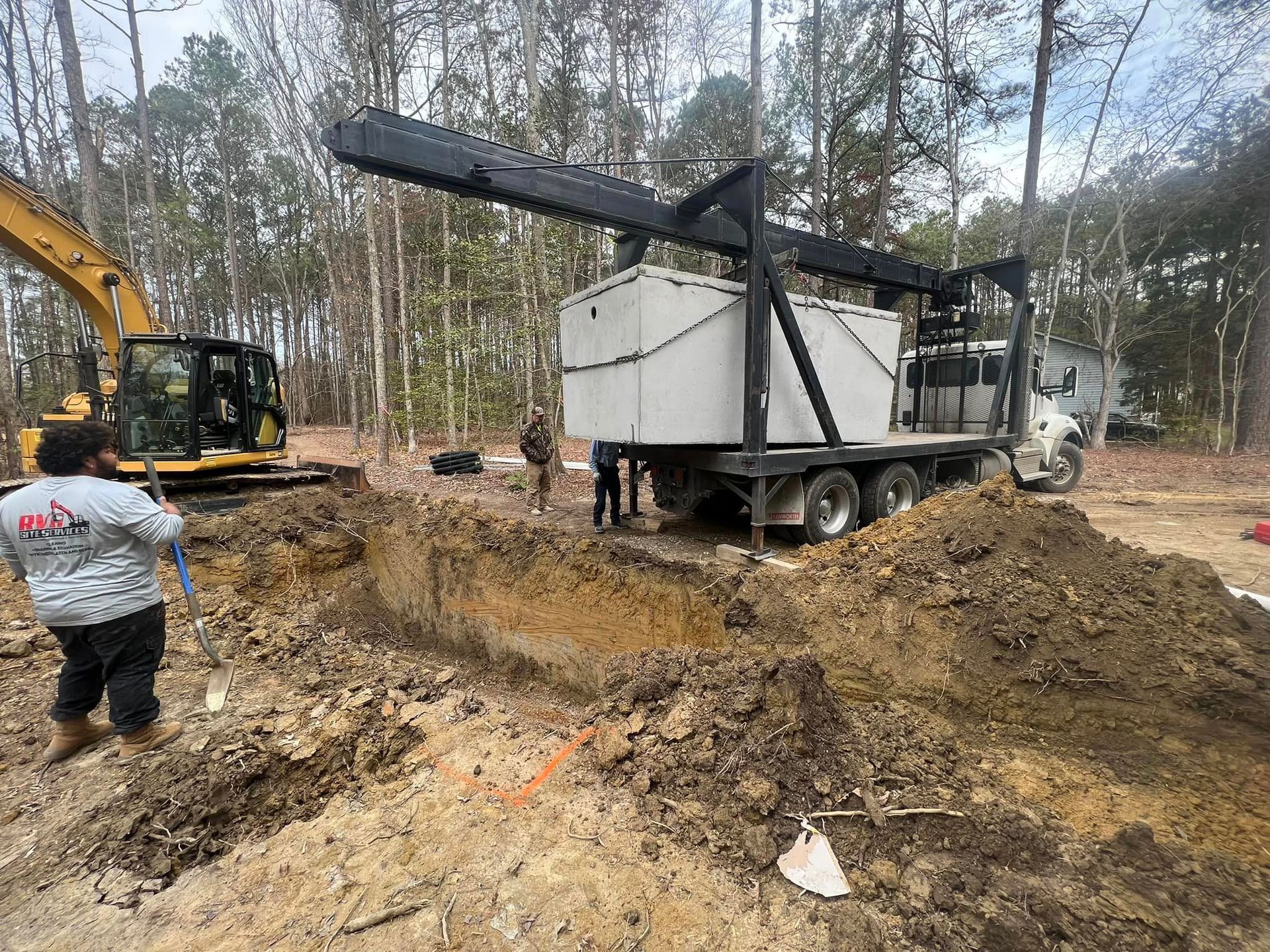 RVA Site Services with equipment delivering and lowering a septic tank.