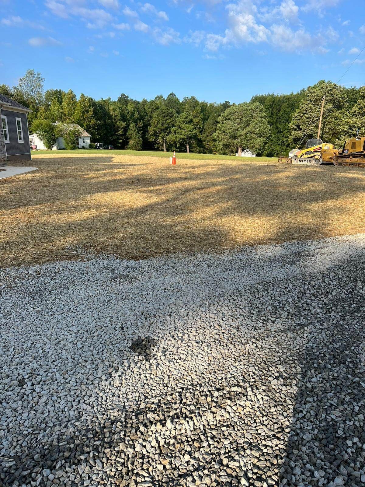 Site grading an erosion-prone area as part of a property drainage project