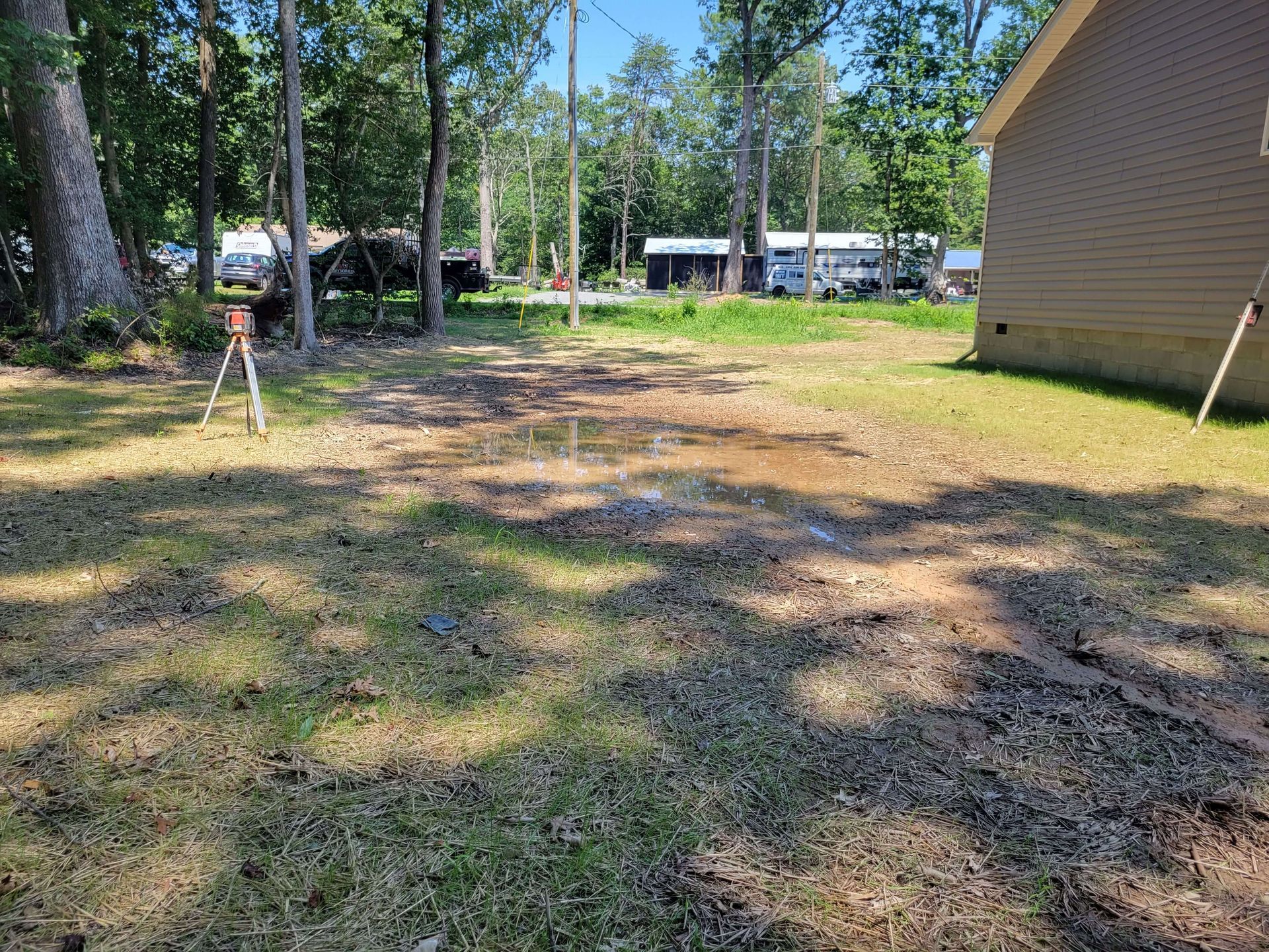 Drainage grading work correcting a low area where rainwater collects