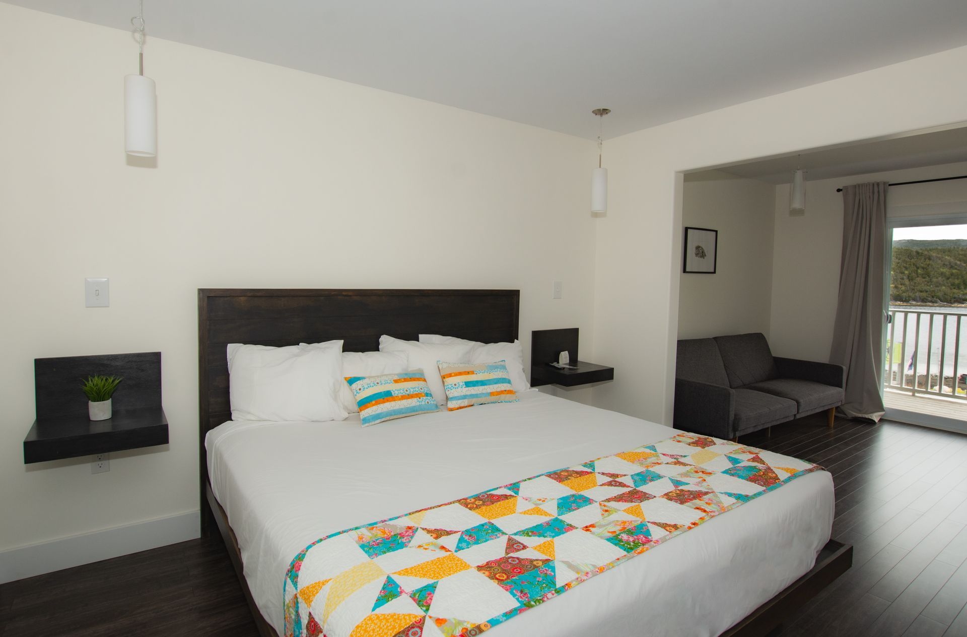 A hotel room with a king size bed and a couch.