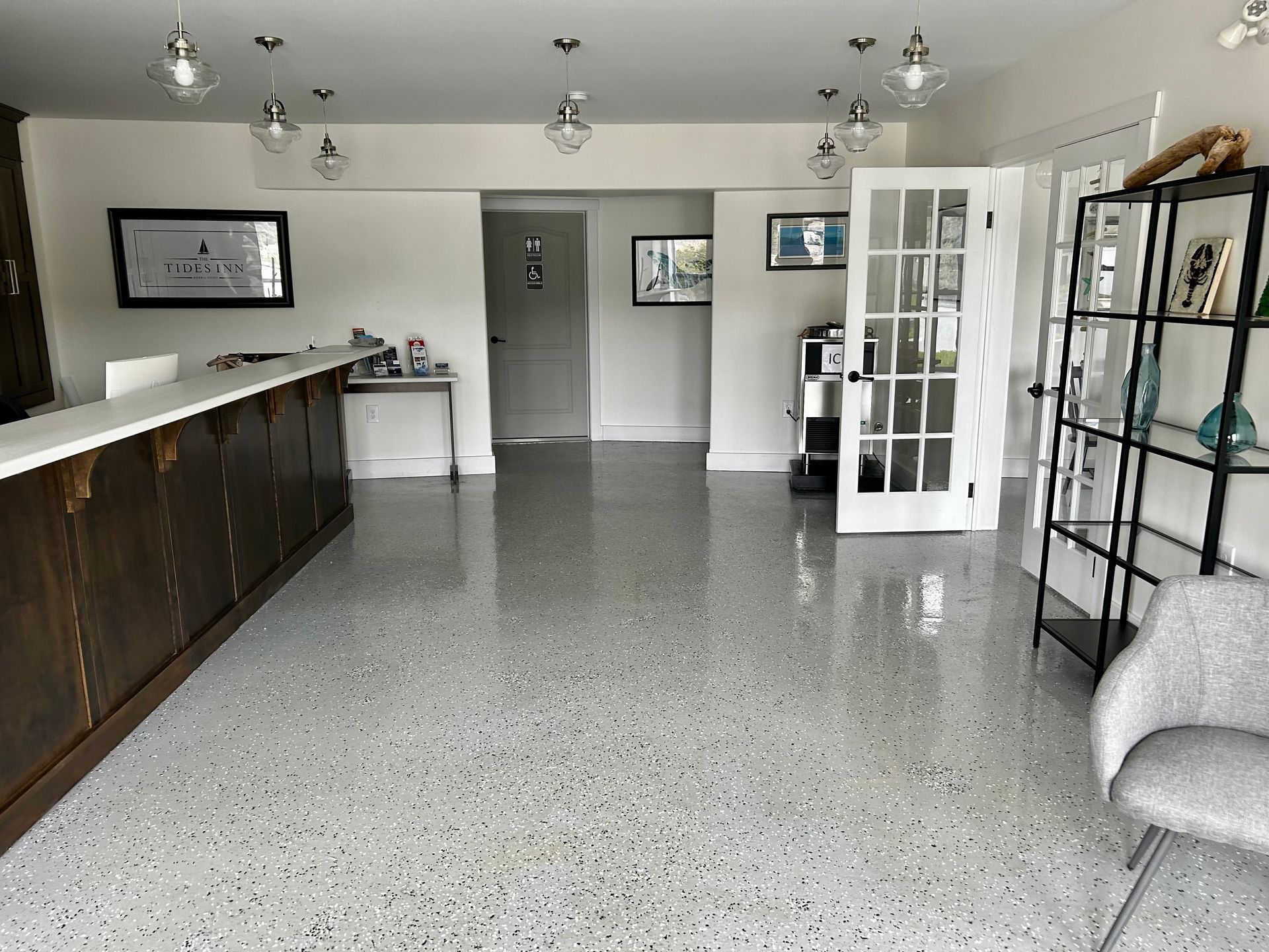 A large room with a counter and a chair in it