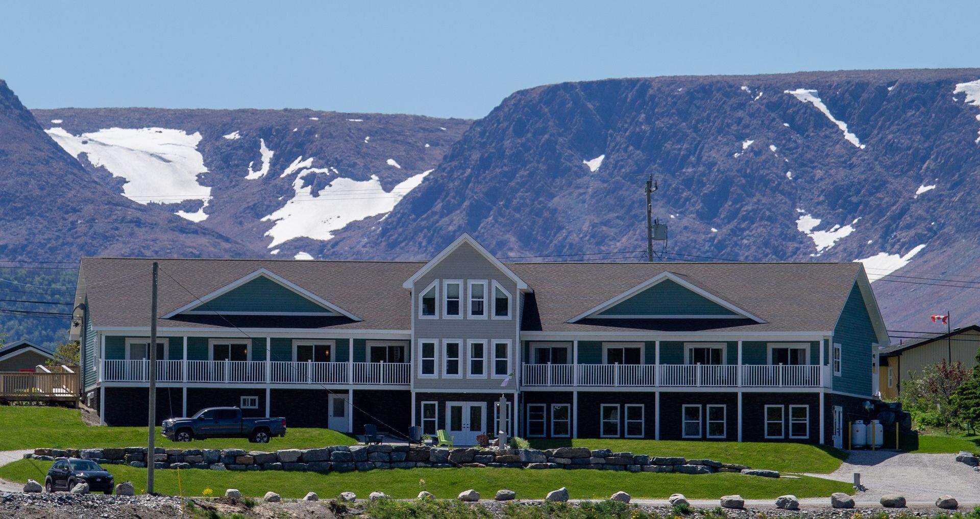 A large house with a mountain in the background