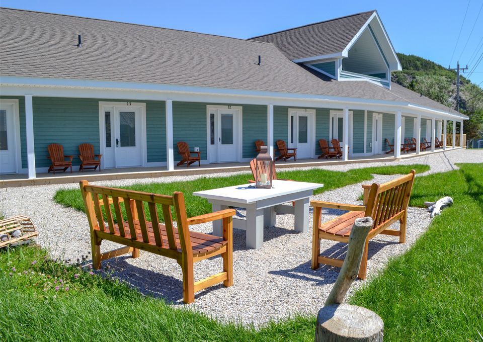 A lawn with a table and chairs in front of a house