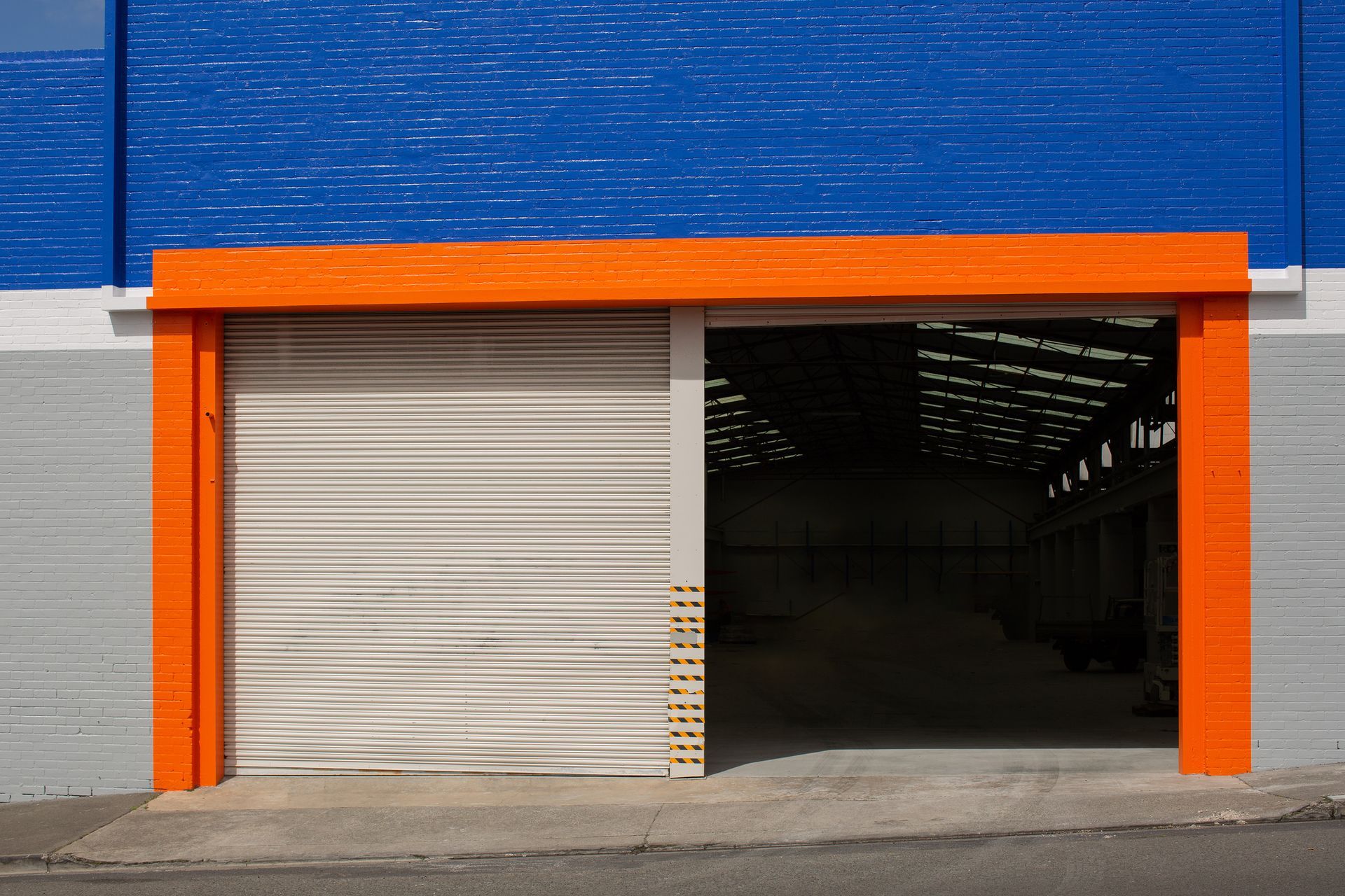 A blue and white building with a white garage door